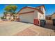 A two car garage in front of a home with desert landscaping at 13321 N 124Th Ave, El Mirage, AZ 85335