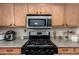 Close-up of the kitchen features stainless steel appliances and wooden cabinetry at 13321 N 124Th Ave, El Mirage, AZ 85335