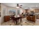 Open-concept kitchen and dining area with tile floors and natural light at 13321 N 124Th Ave, El Mirage, AZ 85335