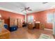 Bright home office featuring built-in wooden cabinets and a ceiling fan, offering plenty of storage at 13321 N 124Th Ave, El Mirage, AZ 85335