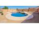 Private backyard pool surrounded by desert landscaping for low maintenance and enjoyable outdoor living at 13321 N 124Th Ave, El Mirage, AZ 85335