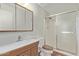 Cozy bathroom featuring a single sink vanity, wood look toilet seat, and tiled walk-in shower at 14426 N 52Nd Ave, Glendale, AZ 85306