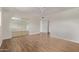 Well-lit bedroom boasts wood floors, a ceiling fan, and large mirrored closet doors at 14426 N 52Nd Ave, Glendale, AZ 85306