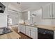 Functional kitchen features wood countertops, a dual basin sink, white cabinets, and a black dishwasher at 14426 N 52Nd Ave, Glendale, AZ 85306