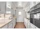 Functional kitchen with white cabinetry, laminate countertops, and tiled flooring at 14426 N 52Nd Ave, Glendale, AZ 85306