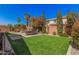 Backyard featuring green grass, a paver patio, shade trees, and a block wall surround at 1446 E Canary Dr, Gilbert, AZ 85297