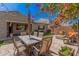 Landscaped backyard with dining area, patio, fire pit, and lush plantings perfect for outdoor living at 1446 E Canary Dr, Gilbert, AZ 85297