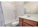 Small bathroom featuring a white tiled tub, shower, and wood vanity at 1446 E Canary Dr, Gilbert, AZ 85297