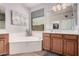 Bright bathroom featuring a soaking tub, double vanity, and neutral decor at 1446 E Canary Dr, Gilbert, AZ 85297