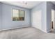 Light blue bedroom with a window, closet, and light gray carpet at 1446 E Canary Dr, Gilbert, AZ 85297