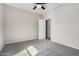 Neutral bedroom features plush carpet, ceiling fan, and an adjacent doorway at 1446 E Canary Dr, Gilbert, AZ 85297