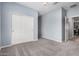 Light blue bedroom with a sliding closet and light gray carpet at 1446 E Canary Dr, Gilbert, AZ 85297