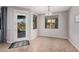 Bright dining area featuring neutral paint, tile floors, and an exit to a landscaped backyard with patio furniture at 1446 E Canary Dr, Gilbert, AZ 85297