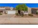 Charming single-Gathering home with a well-manicured front yard and attached two-car garage at 1446 E Canary Dr, Gilbert, AZ 85297