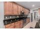 Open kitchen featuring granite counters, wood cabinets, tile backsplash, and stainless steel appliances at 1446 E Canary Dr, Gilbert, AZ 85297