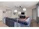 Inviting living room featuring a blue sectional, modern lighting, and neutral walls at 1446 E Canary Dr, Gilbert, AZ 85297