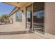 Covered back patio with concrete flooring and large sliding glass doors for indoor-outdoor living at 14837 W Crocus Dr, Surprise, AZ 85379