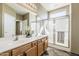 Bathroom features double sinks, tiled floors, a glass shower and natural lighting from windows above the shower at 14837 W Crocus Dr, Surprise, AZ 85379