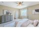 Bright bedroom boasts a comfortable bed, soft hues, coordinated furnishings, and ample natural light, creating a serene ambiance at 14837 W Crocus Dr, Surprise, AZ 85379
