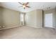 The bedroom has neutral carpet and paint, a ceiling fan, and a single window at 14837 W Crocus Dr, Surprise, AZ 85379