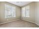 Neutral bedroom with soft carpet and natural light from its large windows, creating a tranquil ambiance at 14837 W Crocus Dr, Surprise, AZ 85379