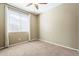 Simple bedroom with soft carpet and a large window offering a bright, versatile space at 14837 W Crocus Dr, Surprise, AZ 85379