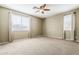 Bedroom featuring a large window, neutral paint and carpet, and curtains at 14837 W Crocus Dr, Surprise, AZ 85379