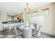 Bright dining area with a round glass table, gray chairs, and neutral tones offering an inviting space for meals at 14837 W Crocus Dr, Surprise, AZ 85379