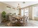 Bright dining area with wooden table, wicker chairs, and sliding glass doors at 14837 W Crocus Dr, Surprise, AZ 85379