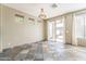 Empty dining space with a sliding glass door, slate flooring, and neutral wall color at 14837 W Crocus Dr, Surprise, AZ 85379