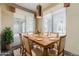 Dining area featuring a rustic table, striped chairs, and a decorative chandelier at 14837 W Crocus Dr, Surprise, AZ 85379