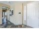 Inviting foyer boasts tile flooring, neutral paint, and a security system panel at 14837 W Crocus Dr, Surprise, AZ 85379
