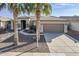 Charming single-story home with a desert landscape, tile roof, and an attached two-car garage at 14837 W Crocus Dr, Surprise, AZ 85379