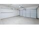 Clean, spacious garage with shelving and an automatic door opener at 14837 W Crocus Dr, Surprise, AZ 85379