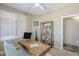 Bright home office featuring a wooden desk, stylish chair, and decorative shelving at 14837 W Crocus Dr, Surprise, AZ 85379