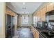 Kitchen featuring maple cabinets, black tile backsplash, and stainless steel appliances at 14837 W Crocus Dr, Surprise, AZ 85379