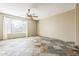 Spacious living room featuring slate flooring, a large window, and neutral walls at 14837 W Crocus Dr, Surprise, AZ 85379