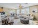 Open-concept living and dining area with tile floors, natural light, and modern furnishings at 14837 W Crocus Dr, Surprise, AZ 85379