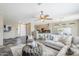 Comfortable living room open to kitchen area, featuring tile floors, plush sofa, and neutral walls at 14837 W Crocus Dr, Surprise, AZ 85379