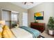 A sunlit main bedroom features a modern dresser and a large sliding closet door at 14837 W Crocus Dr, Surprise, AZ 85379