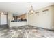 Spacious area that opens to the kitchen featuring slate tile flooring at 14837 W Crocus Dr, Surprise, AZ 85379