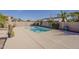 Backyard featuring a sparkling pool with desert landscaping and privacy wall, a perfect oasis at 14837 W Crocus Dr, Surprise, AZ 85379