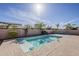 Sparkling blue pool surrounded by lush desert landscaping, perfect for relaxation and recreation at 14837 W Crocus Dr, Surprise, AZ 85379