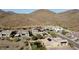 Beautiful aerial view of a neighborhood featuring desert homes with solar panels and mountain views at 1525 W Bent Tree Dr, Phoenix, AZ 85085