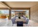 Outdoor dining area with a long table, lush greenery, and pool views at 1525 W Bent Tree Dr, Phoenix, AZ 85085