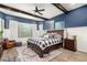 Cozy bedroom featuring a large bed, blue accent wall, and natural lighting at 1525 W Bent Tree Dr, Phoenix, AZ 85085