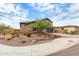 Two-story home with a neutral stucco exterior, tile roof, dark garage door, desert landscaping, and mature landscaping at 1525 W Bent Tree Dr, Phoenix, AZ 85085