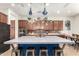 Kitchen island with wooden cabinets, concrete countertops, and pendant lighting at 1525 W Bent Tree Dr, Phoenix, AZ 85085