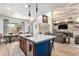 Bright open-concept kitchen and living room featuring a large island and natural wood accents at 1525 W Bent Tree Dr, Phoenix, AZ 85085