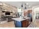 Open-concept kitchen with a large island, wood accents, stainless steel appliances, and hardwood floors at 1525 W Bent Tree Dr, Phoenix, AZ 85085